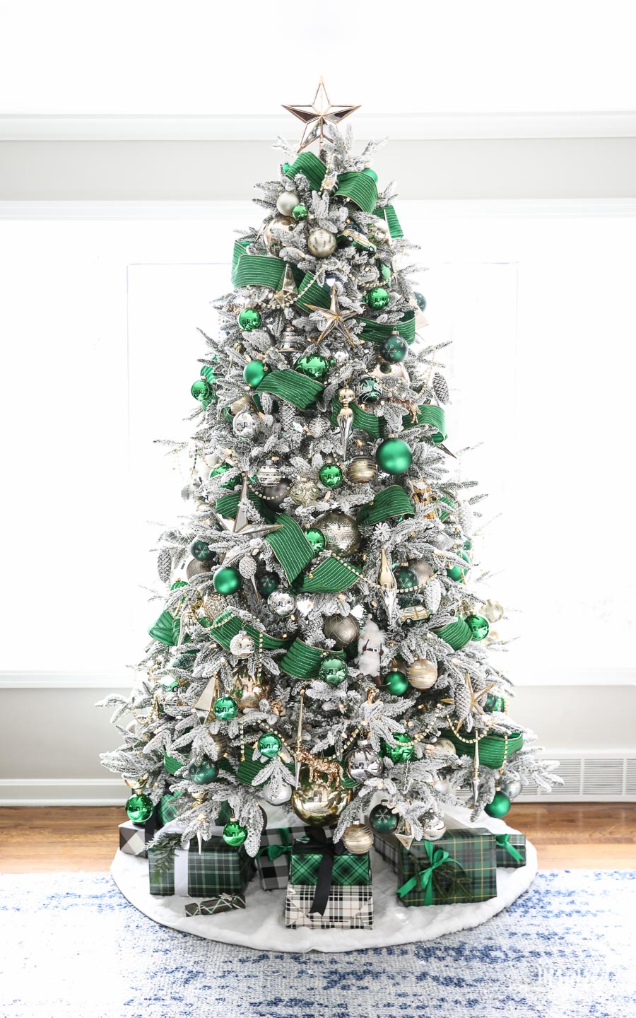 Flocked tree with green ribbon and embellishments. 