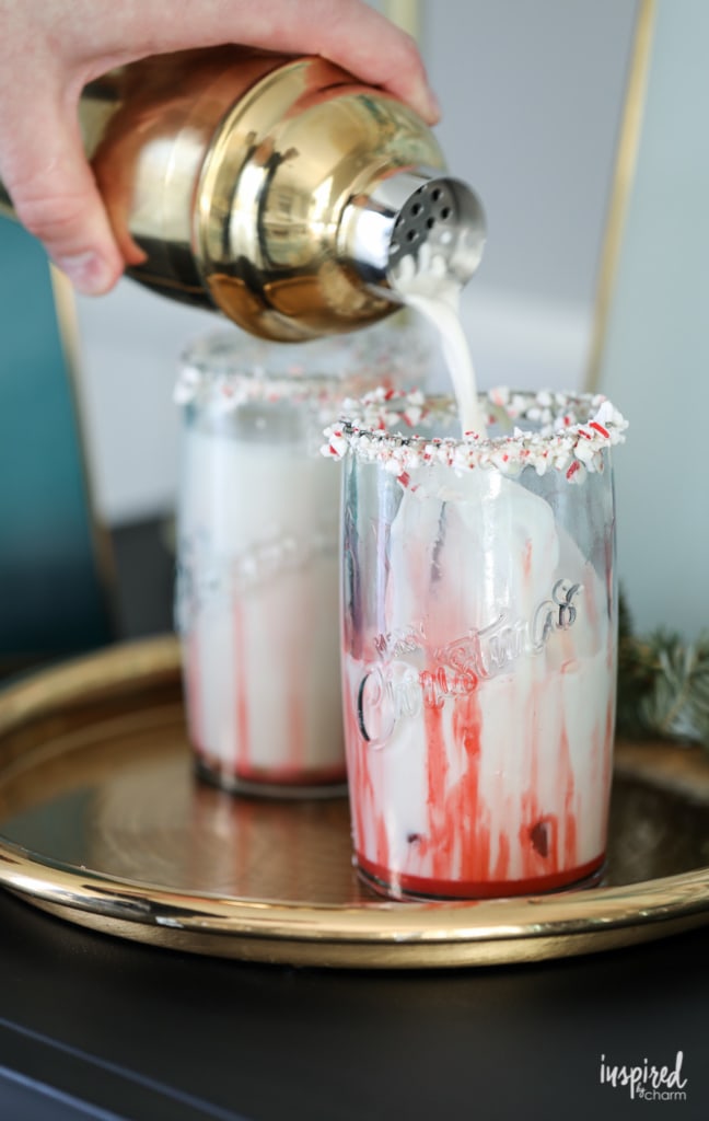 Pouring Peppermint White Russian cocktail into a glass