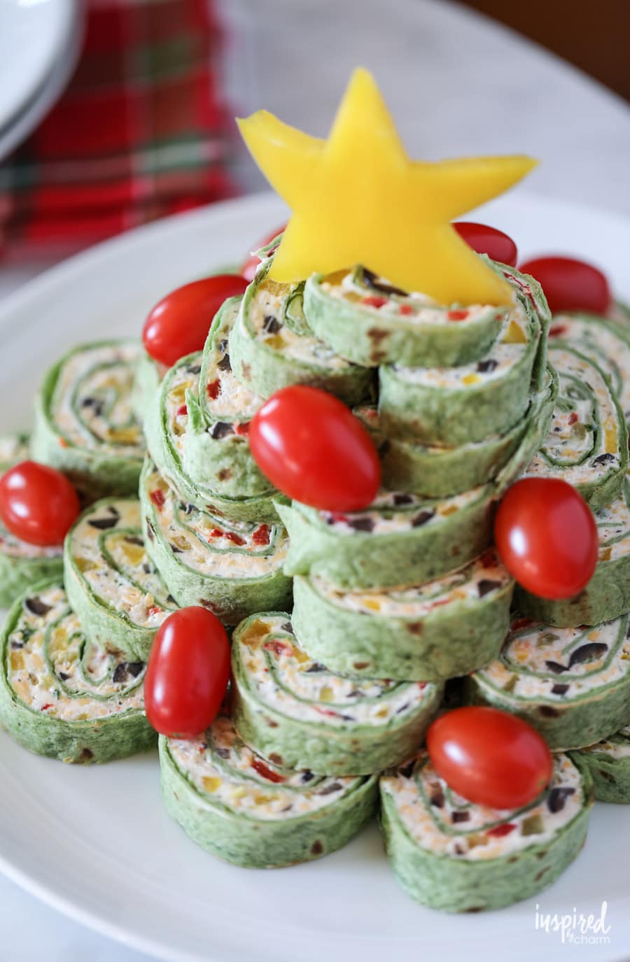Tortilla Roll-ups stacked into a christmas tree on a plate.