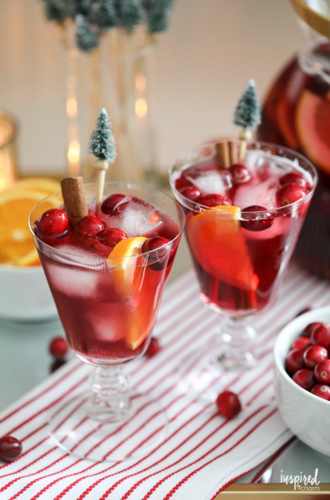 two glasses of Non-Alcoholic Sangria for Christmas garnished with cranberries.