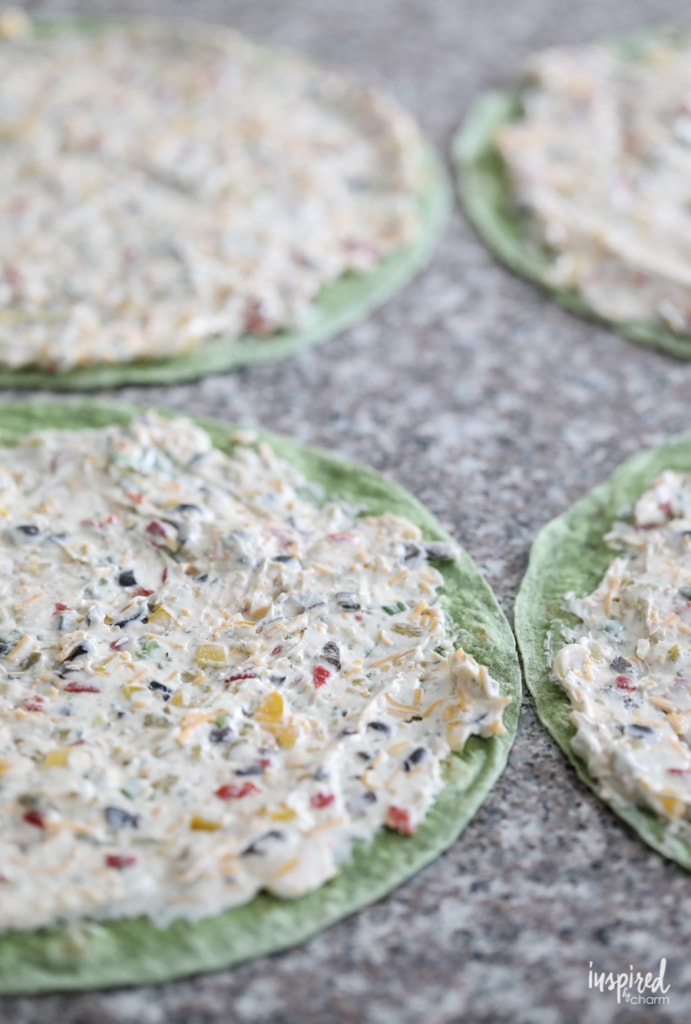 green tortillas spread with cheese and veggie filling.