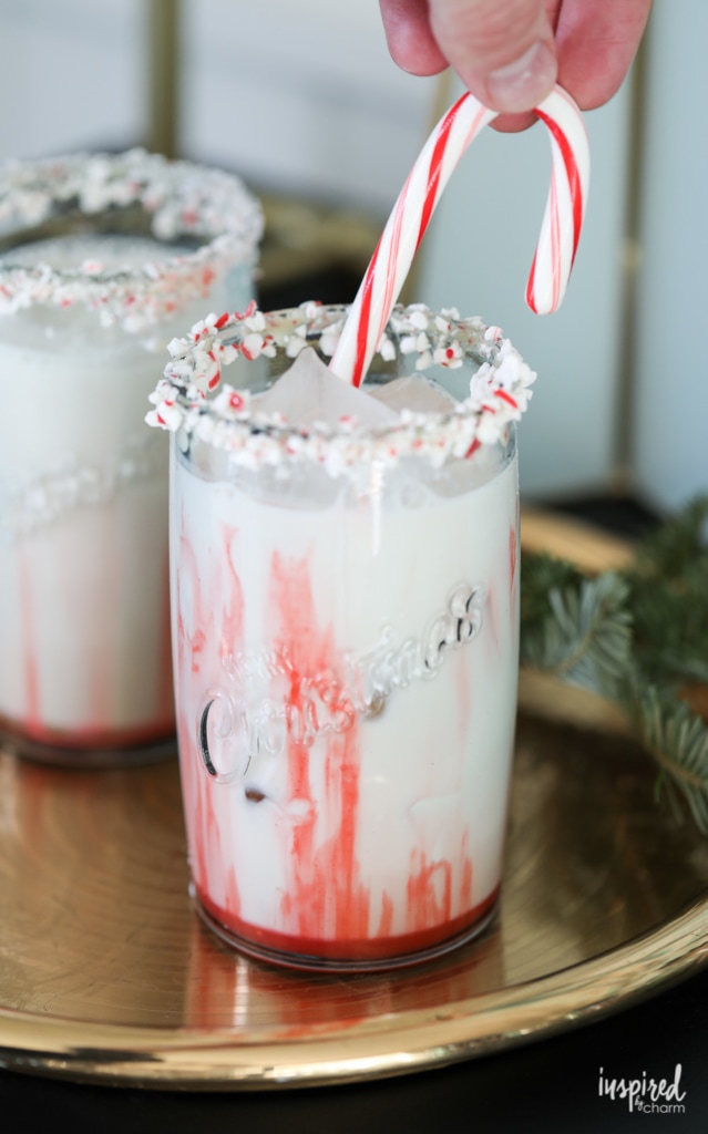 candy cane dipped in a peppermint white Russian Christmas cocktail recipes