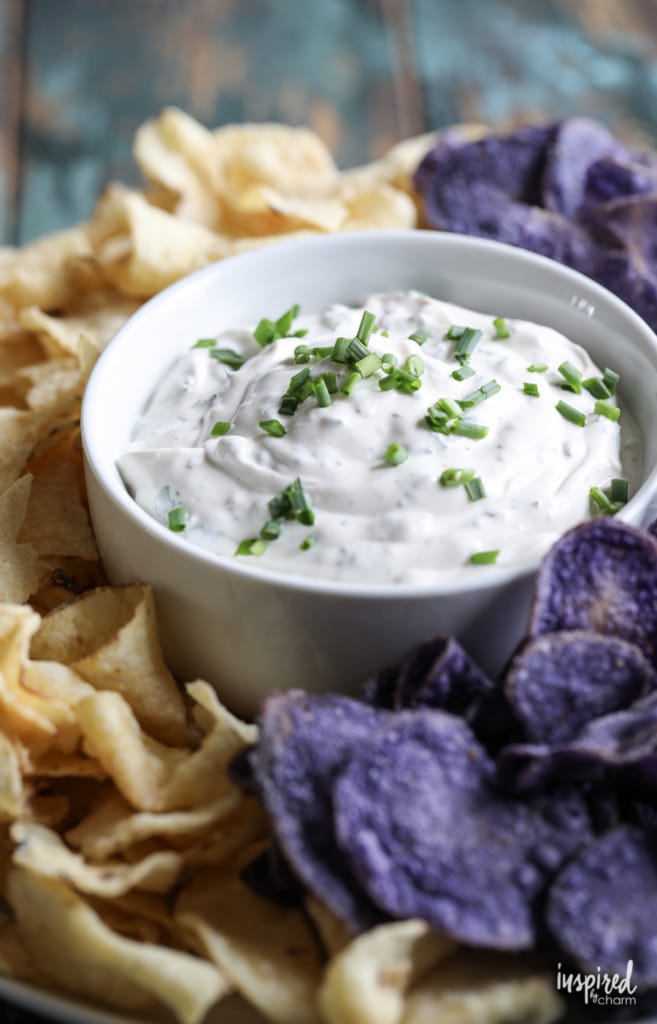 close up of a bowl of homemade chip dip surrounded by chips