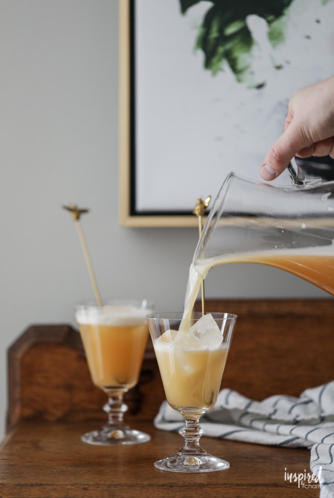 pour a Bee's Knees Cocktail into a glass. 
