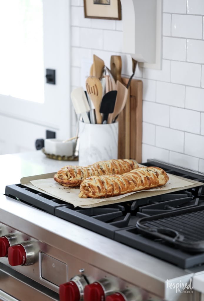 two baked apple strudel loaves on a stove top