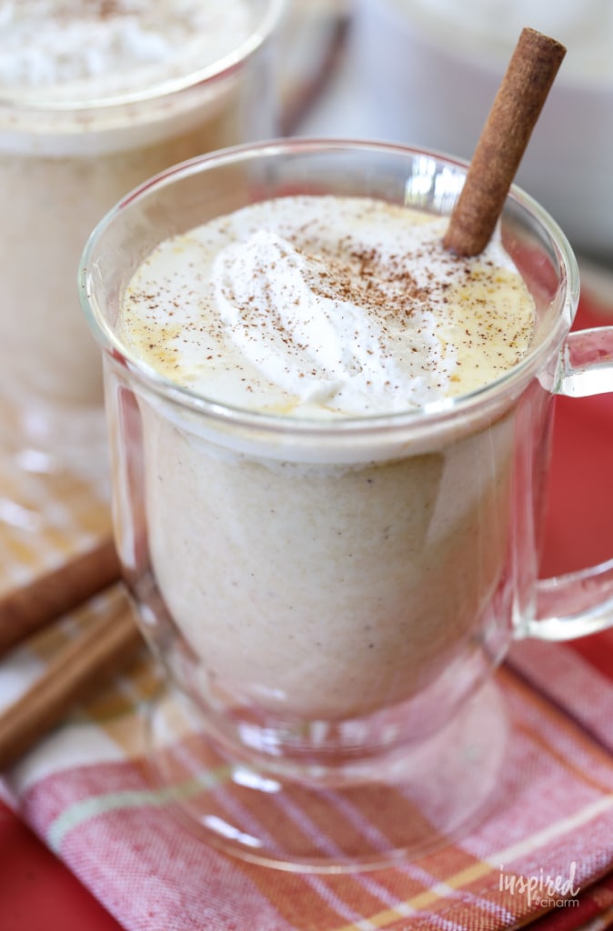 clear mug of white hot chocolate with fall spices on top 