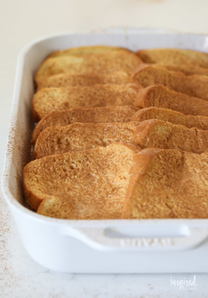 sliced brioche French toast in a baking dish. 