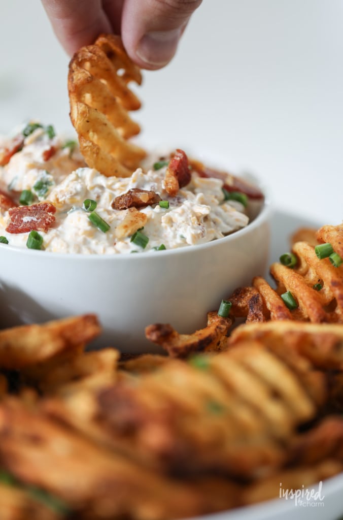 This Loaded Potato Dip served with waffle fries make a delicious and easy appetizer recipe. #loaded #baked #potato #dip #appetizer #recipe #wafflefries 