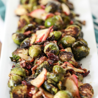 These Roasted Brussels Sprouts with apple, cranberries, and pecans make a tasty fall side dish. #sidedish #fall #recipe #roasted #brusselssprouts #apple #cranberries