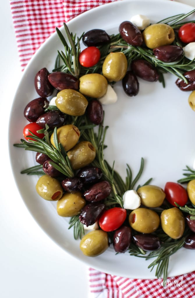 olives tomatoes and herbs shaped into a Christmas wreath form