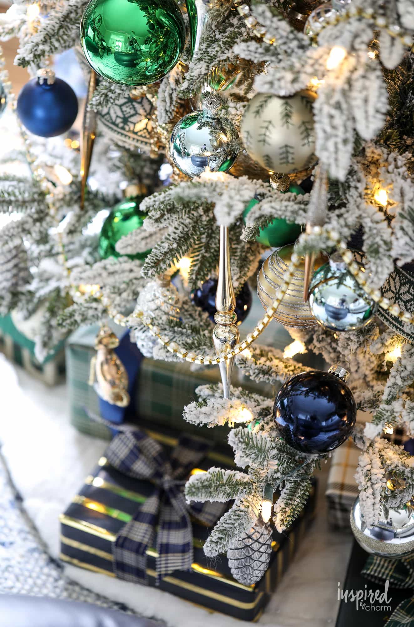 Green and Navy Christmas Tree Decor on a flocked christmas tree. 