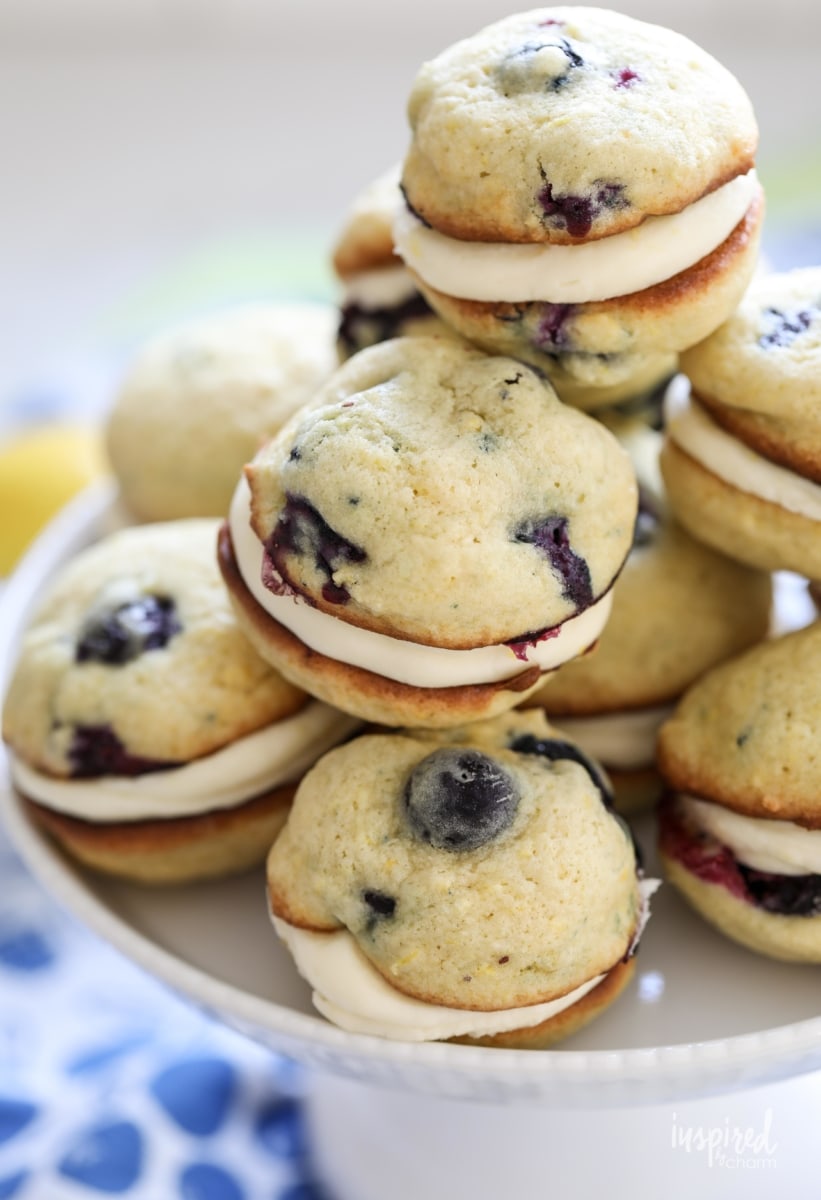Filled with a lemon cream cheese filling and bursting with lemon zest and fresh blueberries, these Blueberry Lemon Whoopie Pies are a delicious dessert. #lemon #blueberry #whoopiepies #recipe 