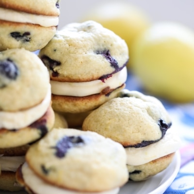 Filled with a lemon cream cheese filling and bursting with lemon zest and fresh blueberries, these Blueberry Lemon Whoopie Pies are a delicious dessert. #lemon #blueberry #whoopiepies #recipe