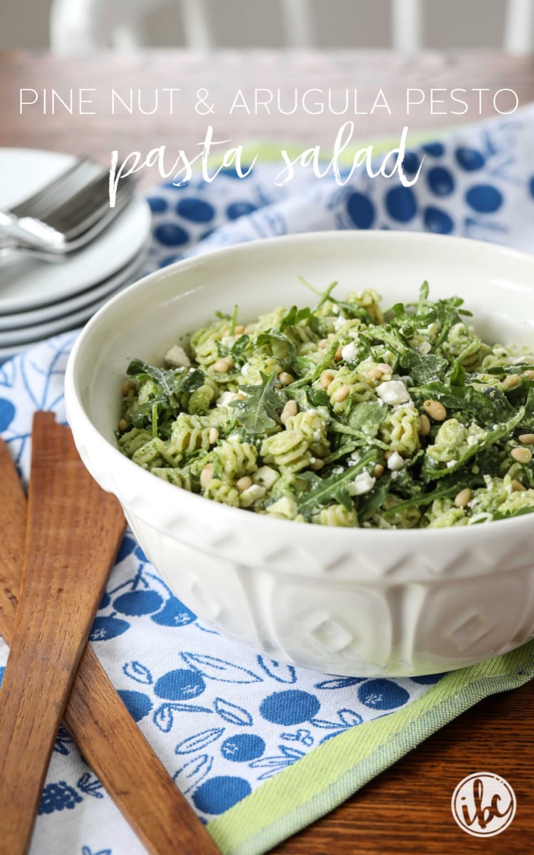 Pine Nut and Arugula Pesto Pasta Salad in a bowl with title text.