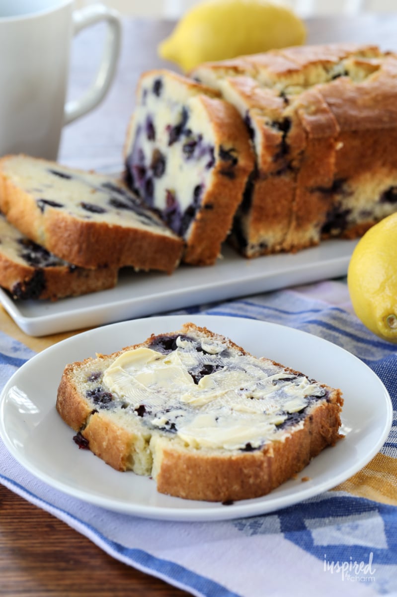 slide of blueberry lemon bread with a whole loaf in the background