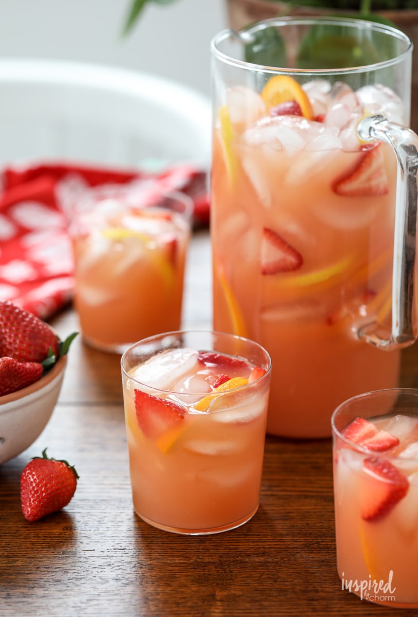 pitcher of campari sangria with floating strawberries