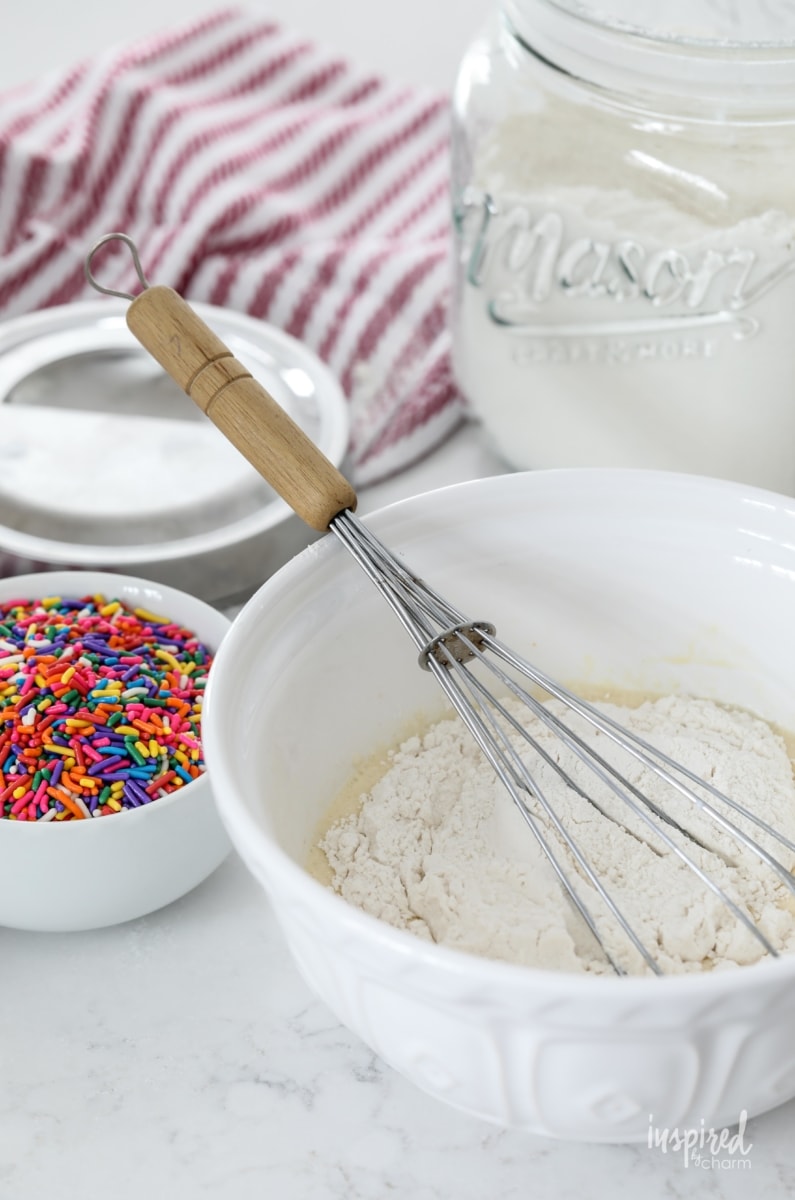 ingredients for funfetti pancakes in bowls. 