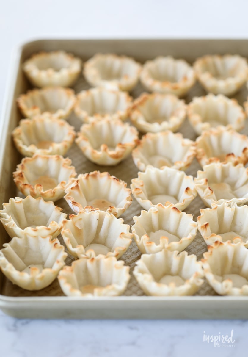 phyllo pastry cups on a baking sheet. 