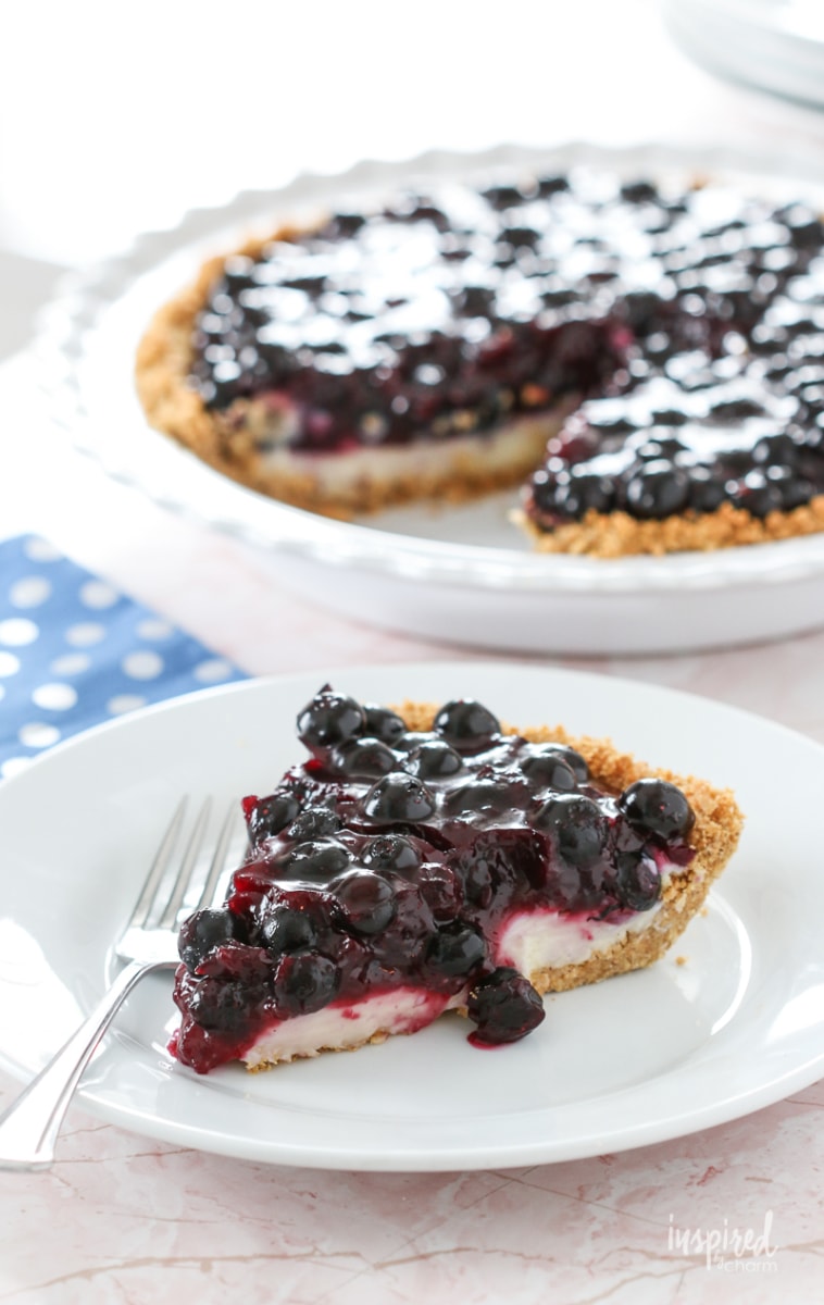 Slice of blueberry cream pie on a plate with a fork