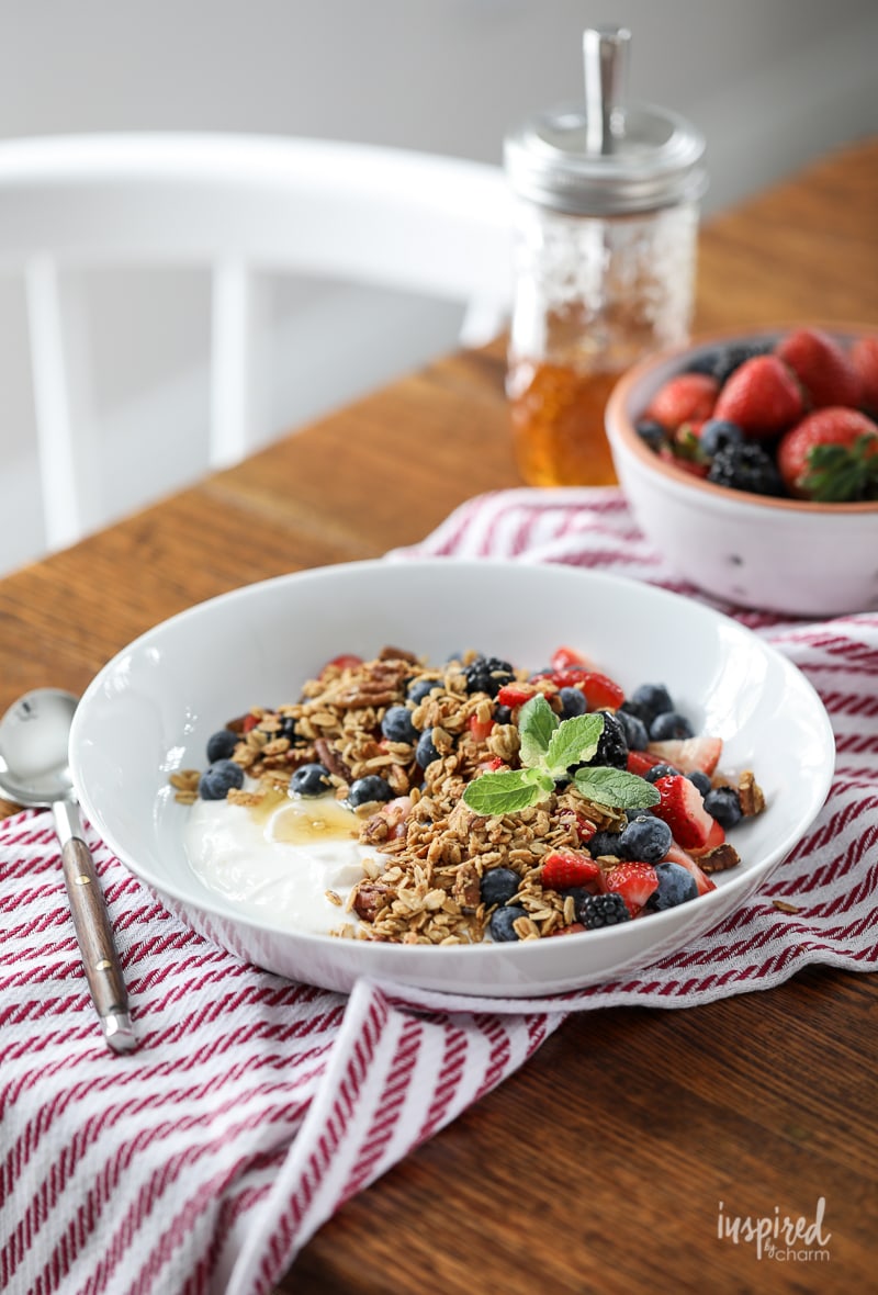 Yogurt with Granola Berries and Honey in a bowl on a table. 