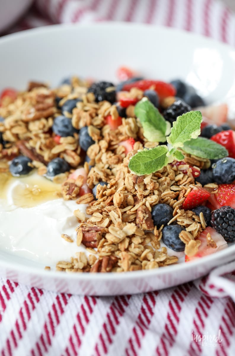 Yogurt with Granola Berries and Honey in a bowl.