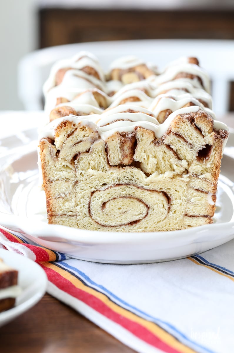 Slice of cinnamon roll bread with icing on top