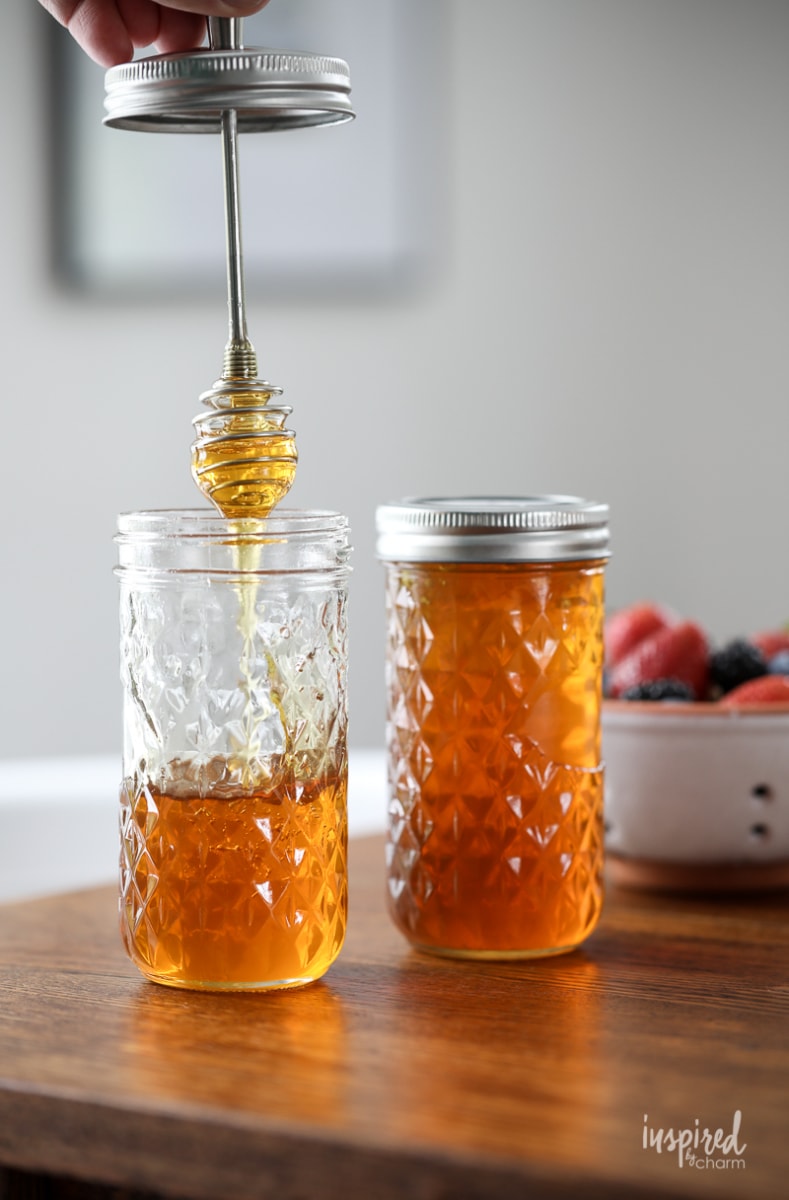 honey dipper being pulled out of a mason jar.