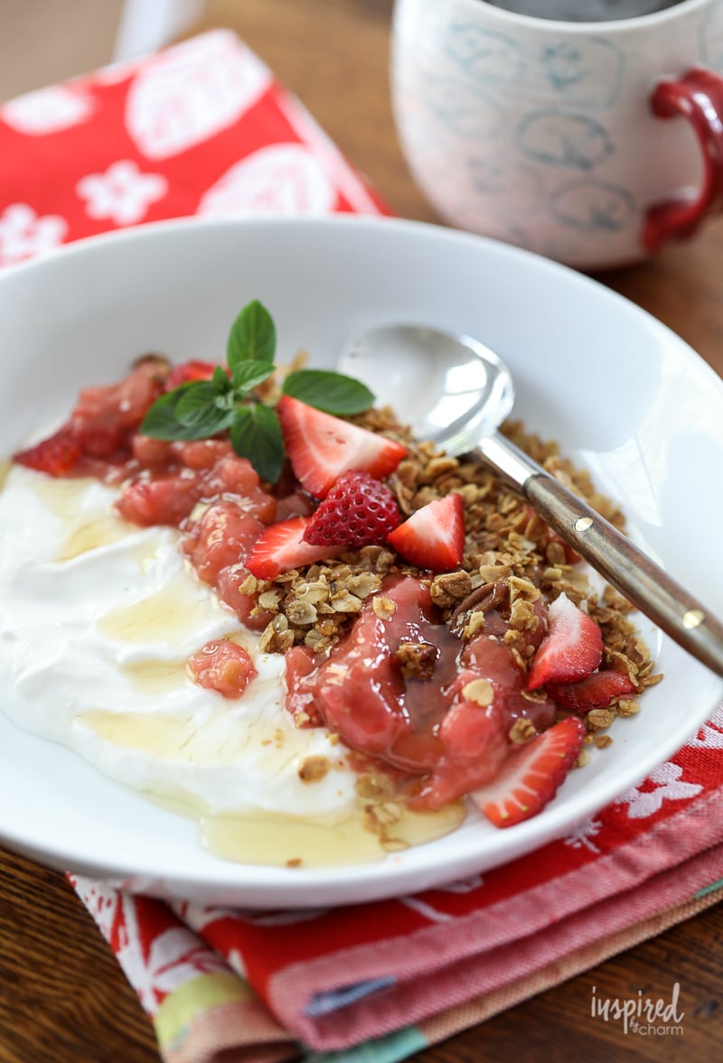 Yogurt with Granola, Strawberry, Rhubarb and Honey in a bowl.