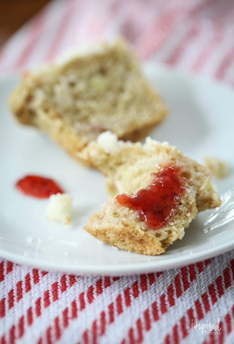 bite out of rhubarb muffin with strawberry jam.