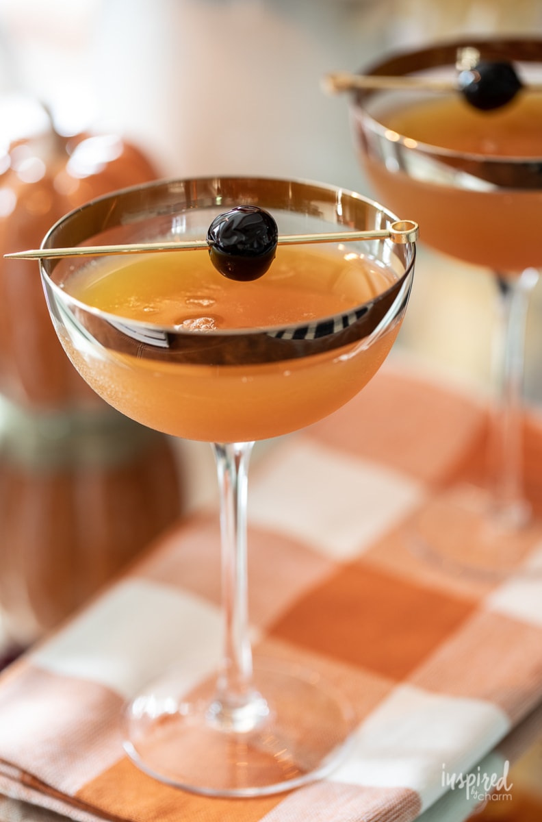 fall flavored Manhattan served with a cherry on a cocktail skewer