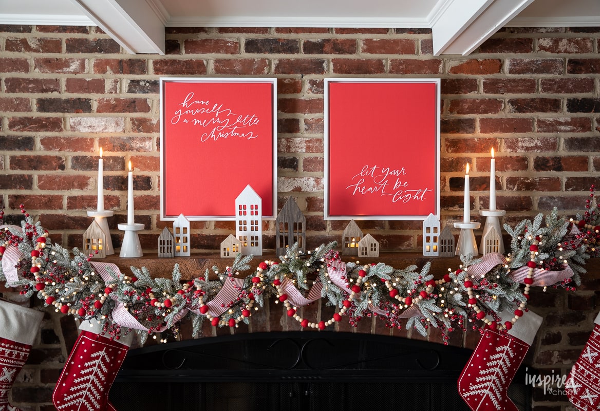red and white canvas decor hung above a fireplace mantel