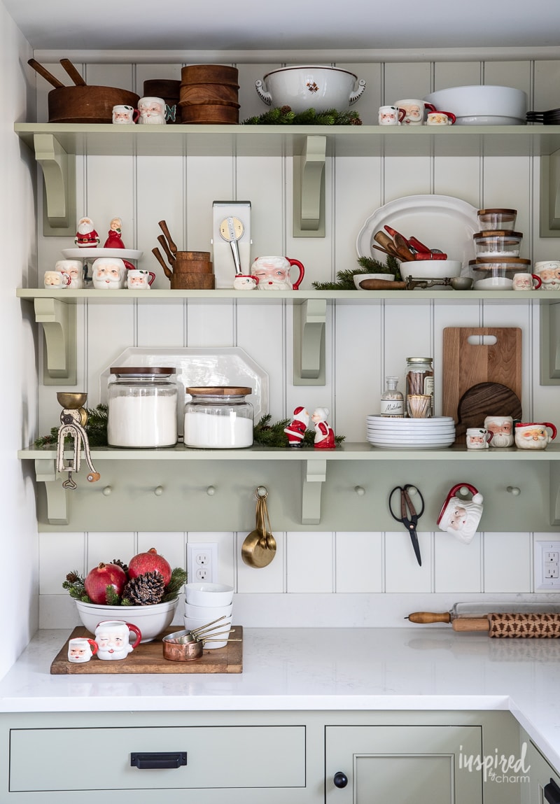 open shelving in butler's pantry with wood and white dishes and Santa mugs