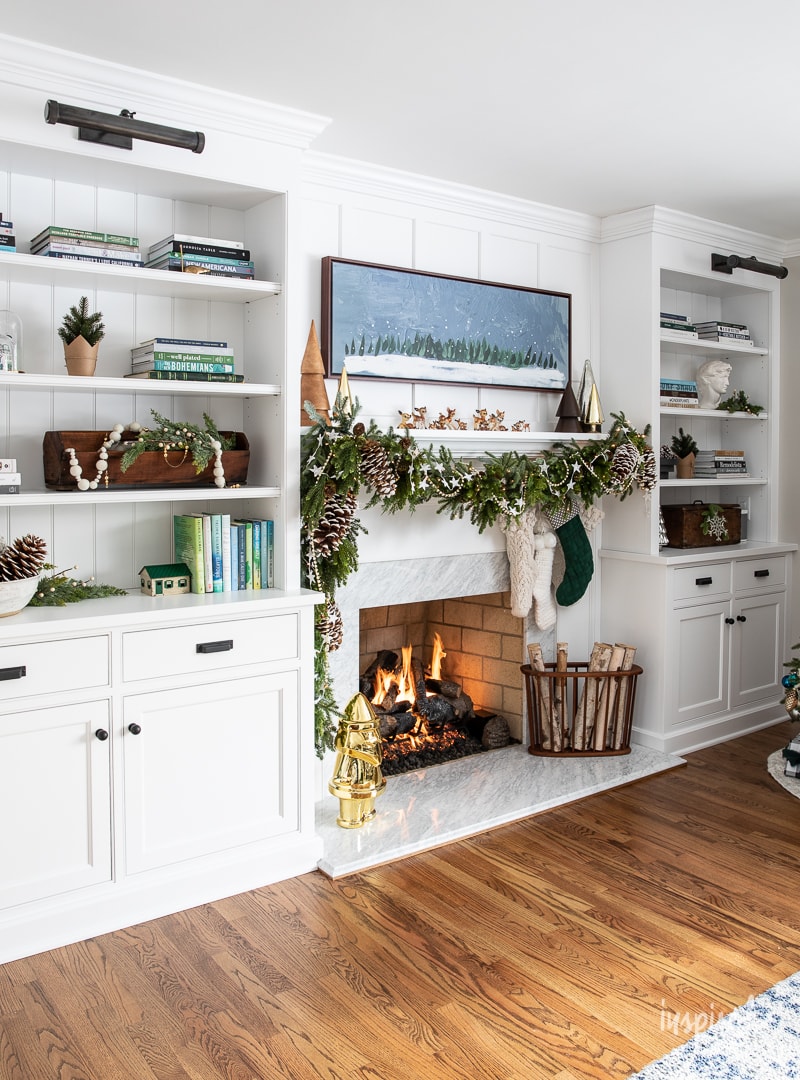 Living Room Christmas Mantel Decor #livingroom #mantel #christmas #fireplace #holiday #decor #bookshelf #bookcase #garland