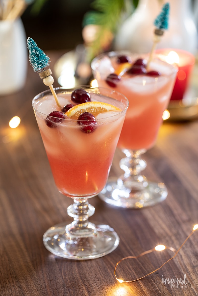 Close up of a cocktail with Christmas tree drink stirrers