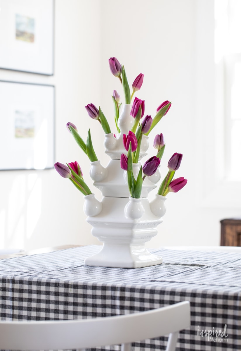 three tier tulipiere vase with purple and pink tulips.