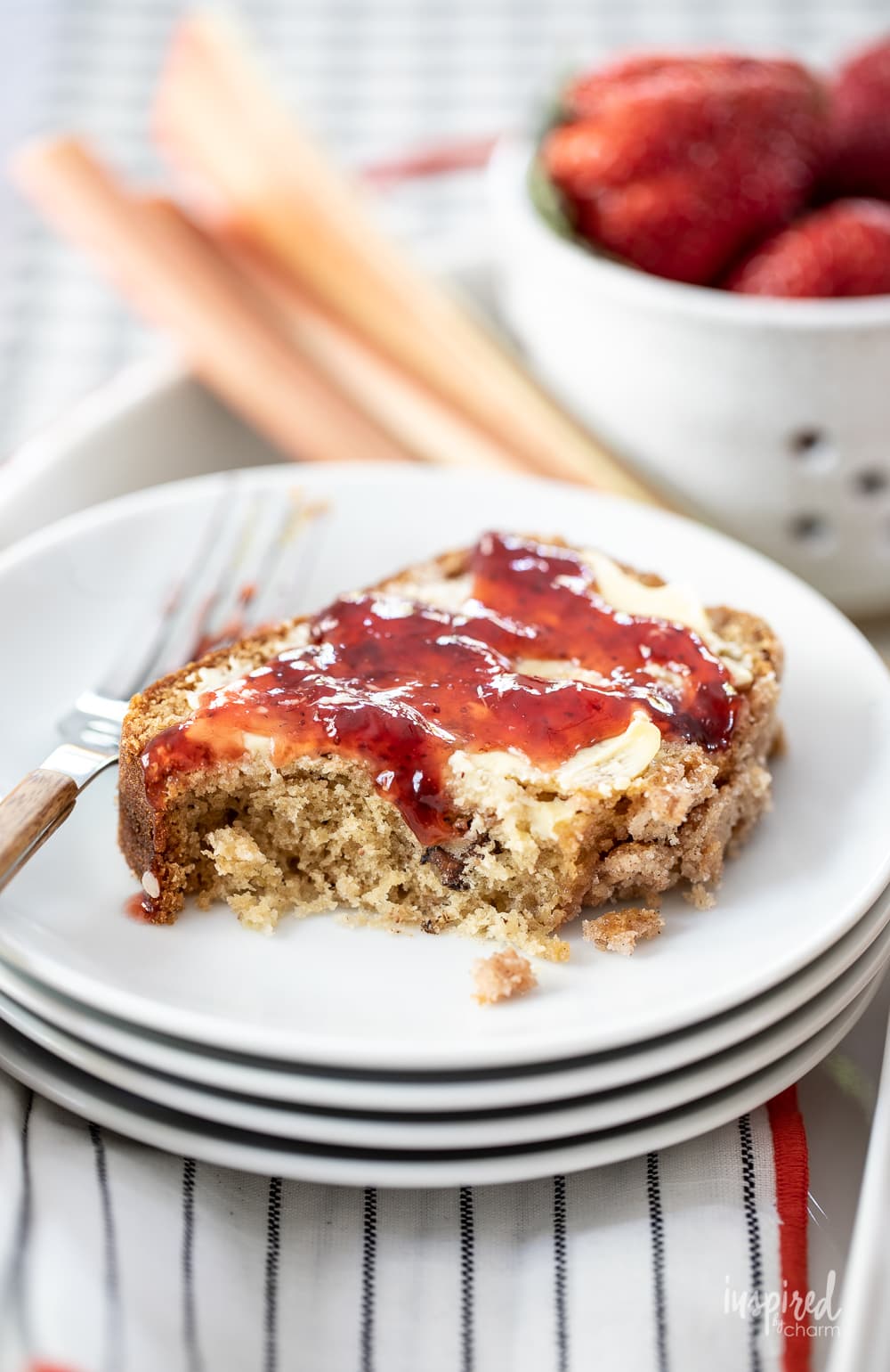 Rhubarb Streusel Quick Bread with butter and strawberry jam on a plate.