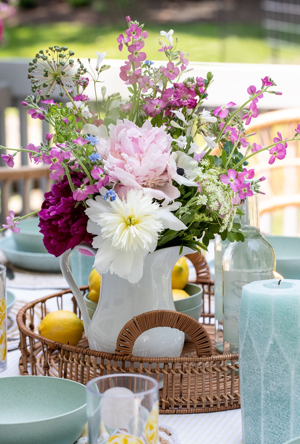 peony flower arrangement on outdoor table setting.