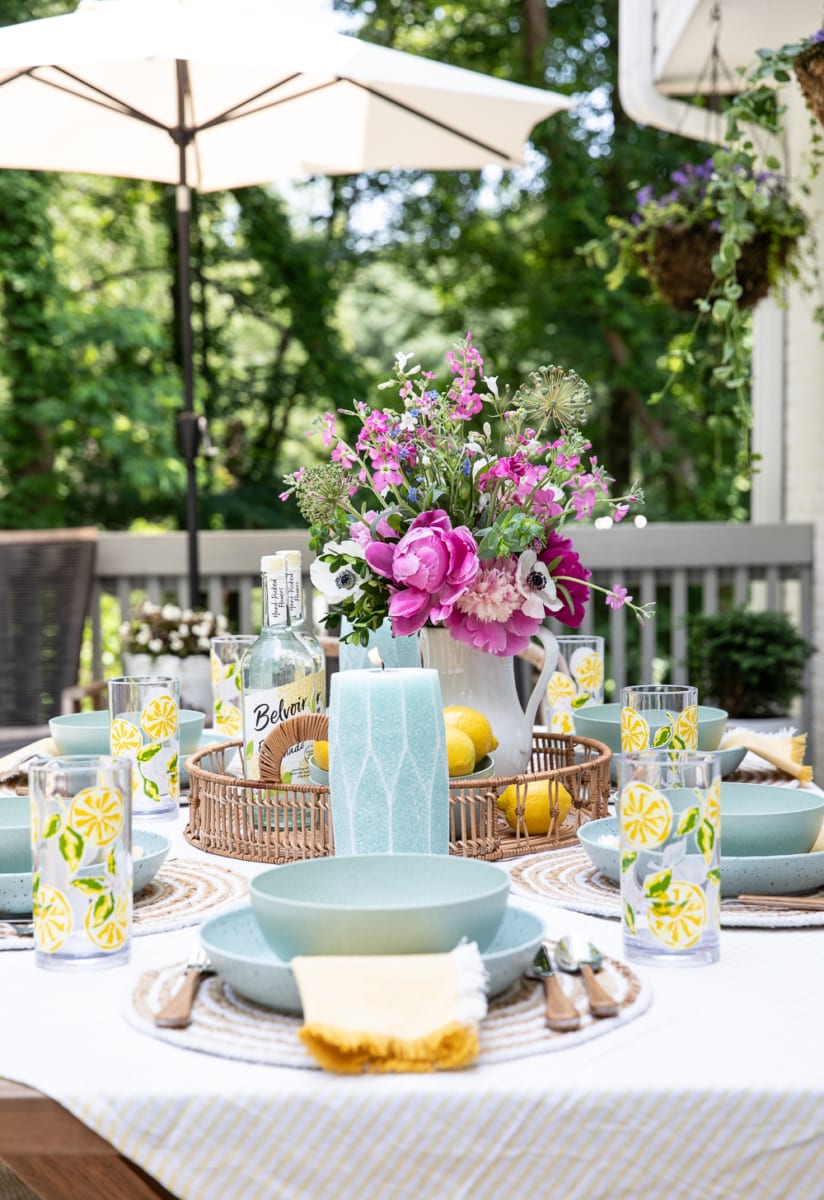 details on a table setting outdoors on a deck.