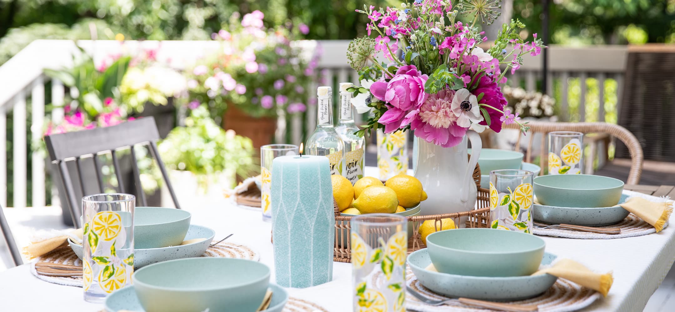 beautiful and colorful table set up outside for entertaining and dinner. 