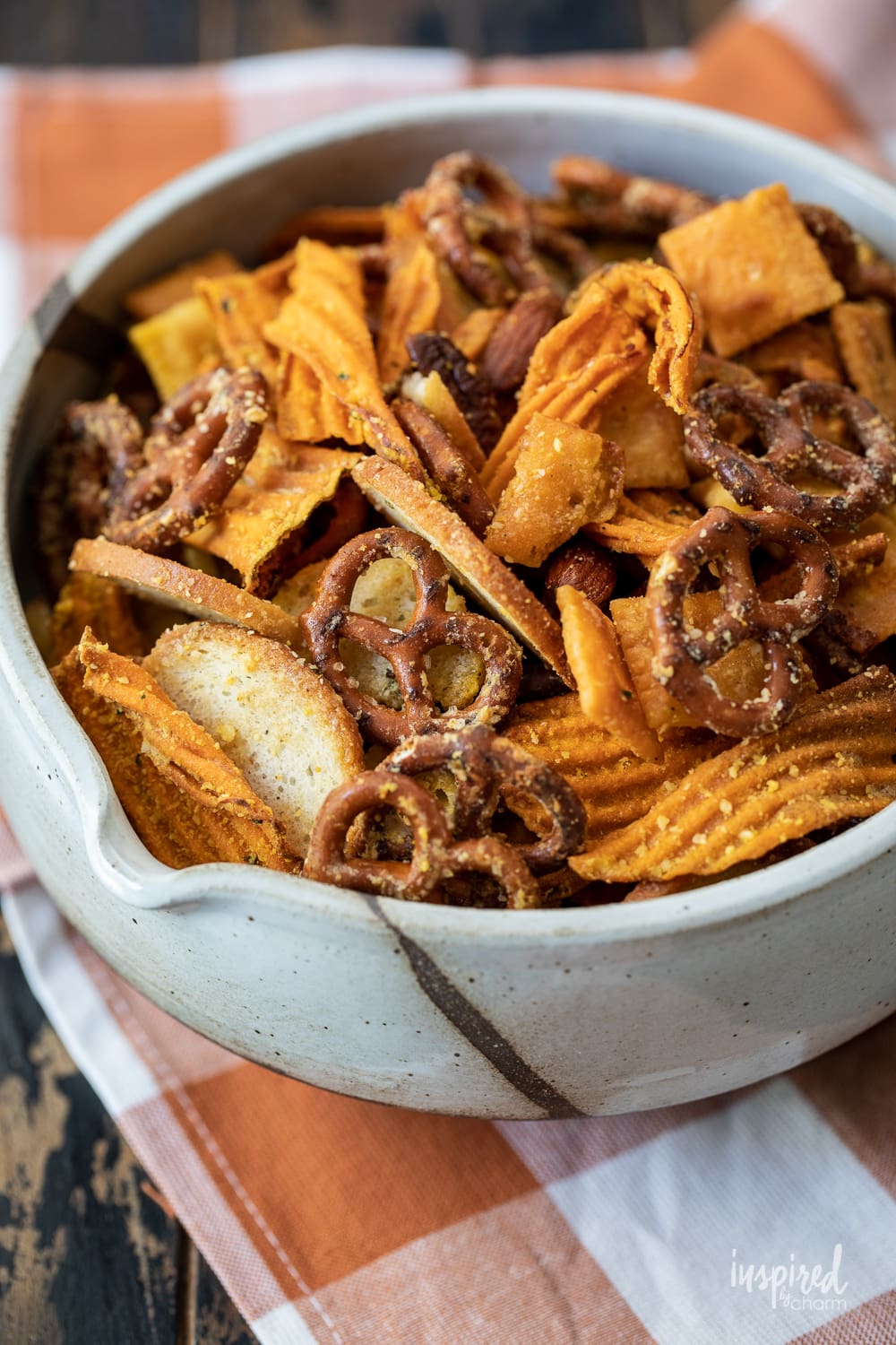 Parmesan ranch snack mix in a white bowl.