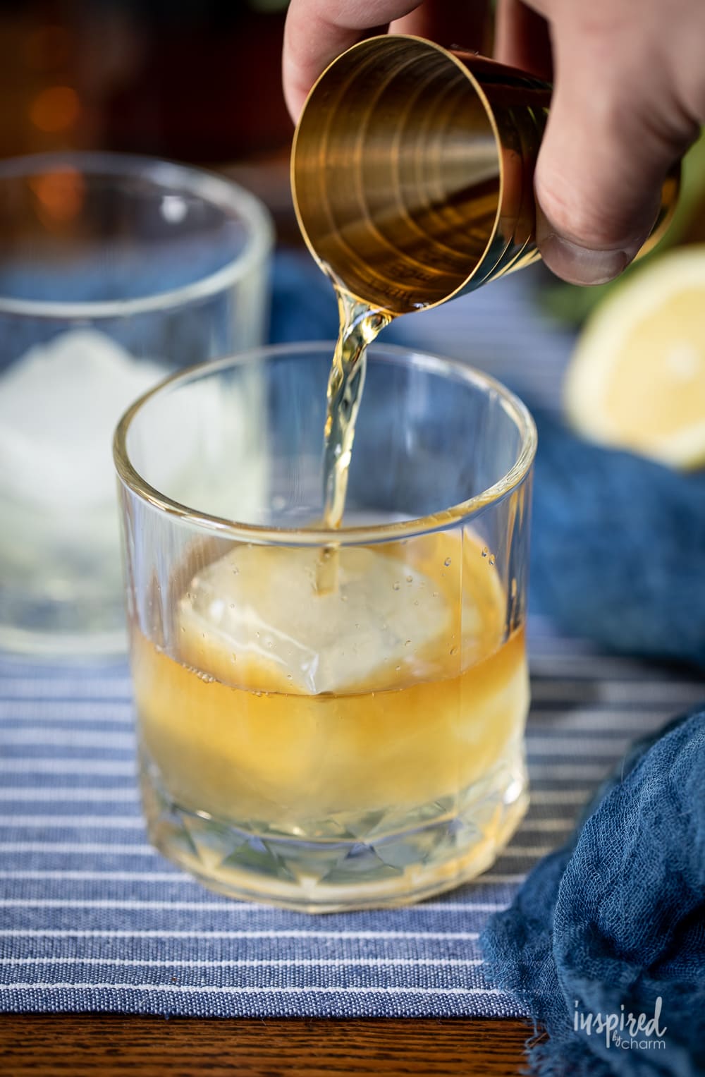adding bourbon to a Bourbon & Sage Cocktail.