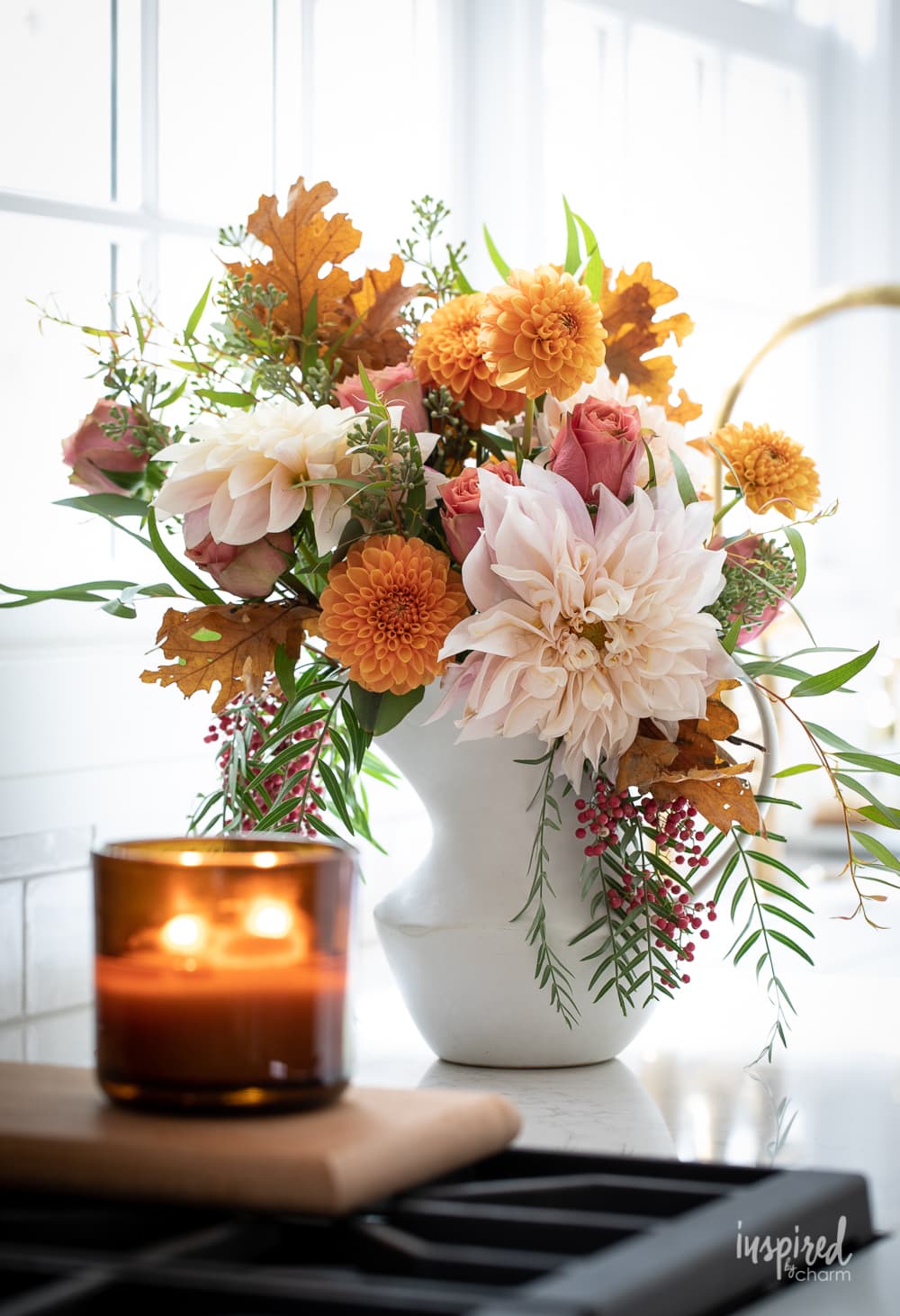 fall flower arrangement with a candle. 