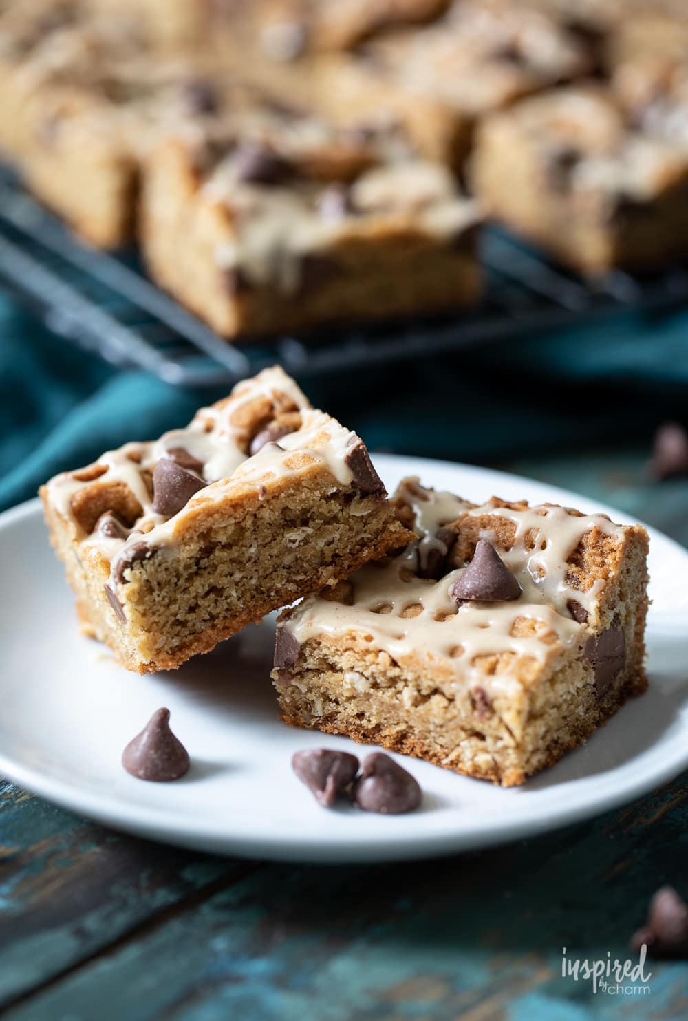 Chocolate Chip Peanut Butter Bars on a white plate with some chocolate chips.
