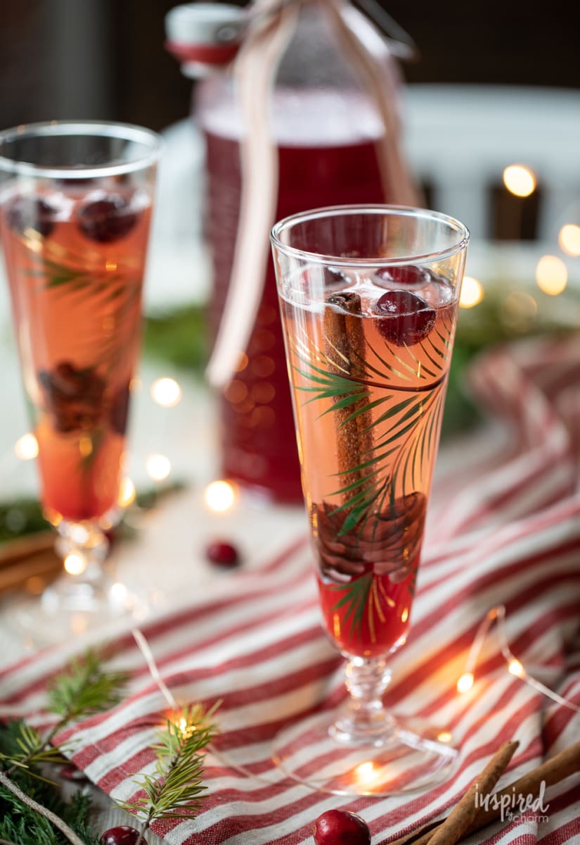 tall flute filled with festive cranberry champagne cocktail 