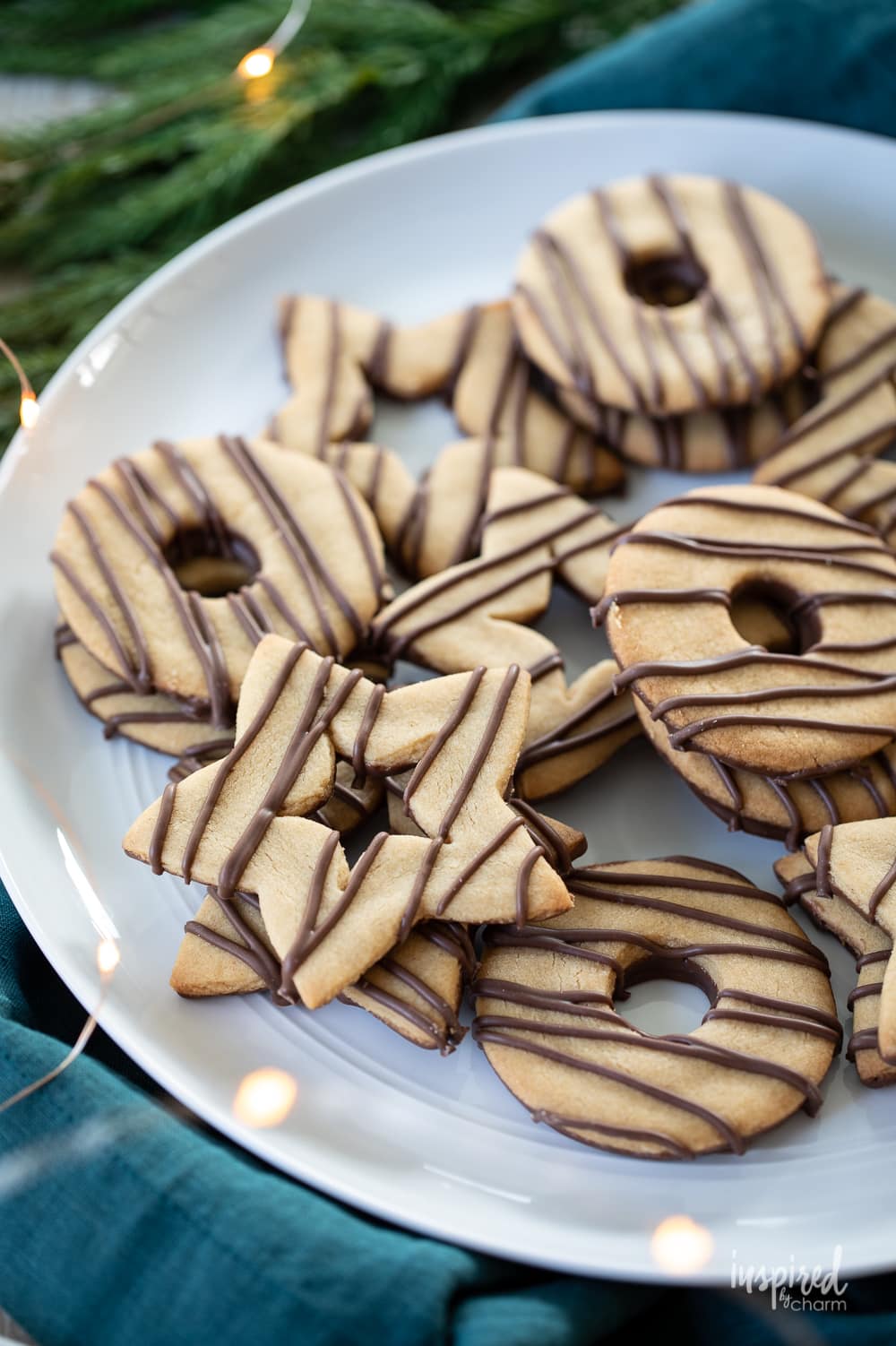 star and circle shaped Chocolate Striped Peanut Butter Shortbread Cookies on a plate.