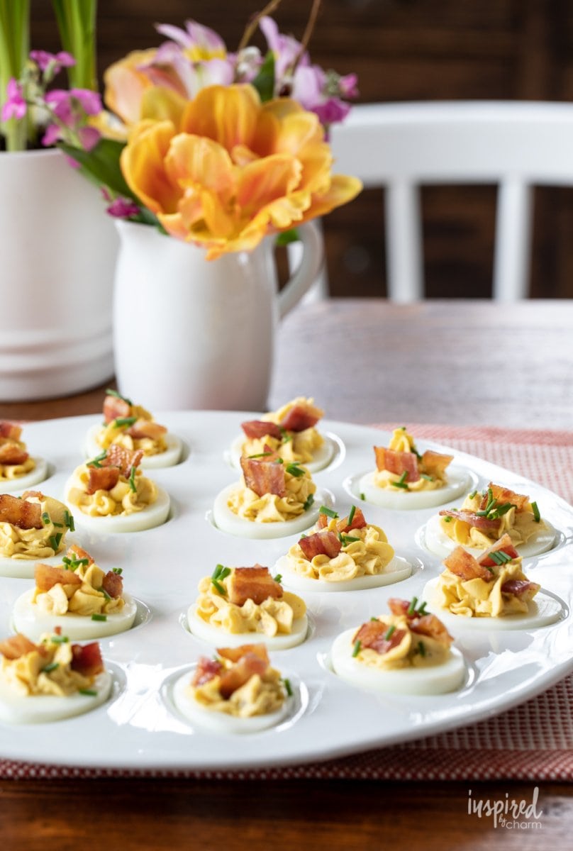 deviled eggs with bacon on a plate