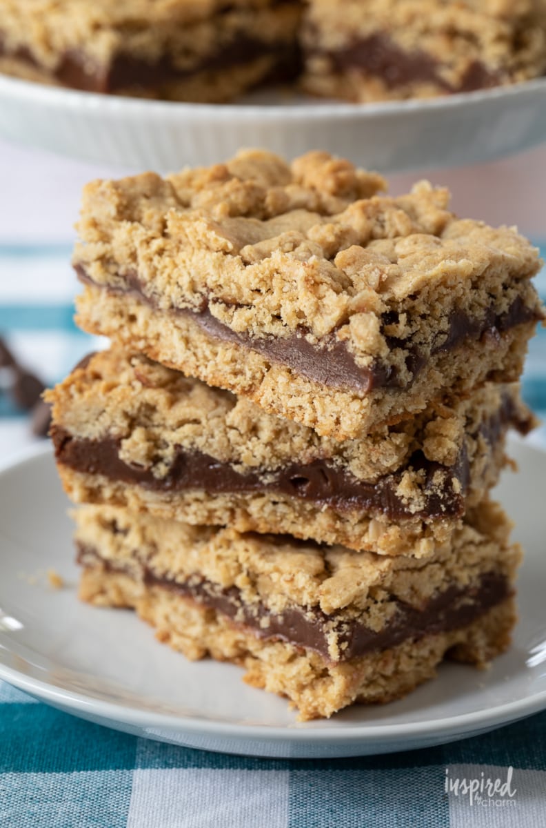 Peanut Butter Oatmeal Fudge Bars stacked three high on plate.