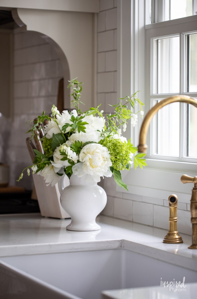 Peony Arrangement in white pitcher on counter