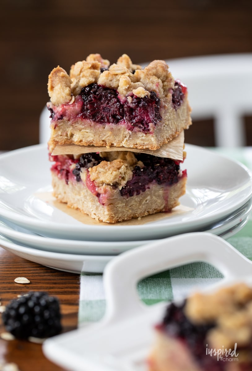 Blackberry Crumb Bars stacked on plate.