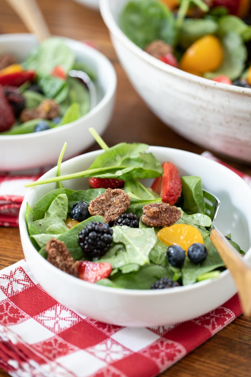bowls of spinach salad with berries.